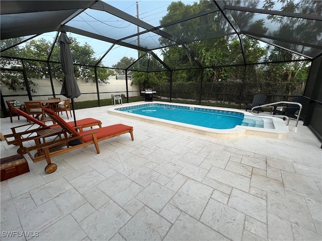 view of pool with a lanai and a patio