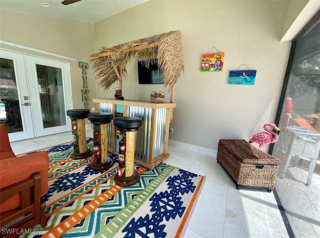 interior space with french doors and light tile patterned flooring