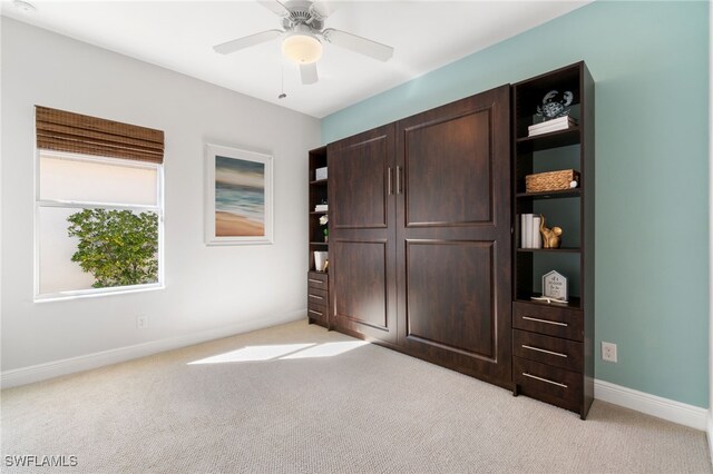 unfurnished bedroom featuring light colored carpet and ceiling fan