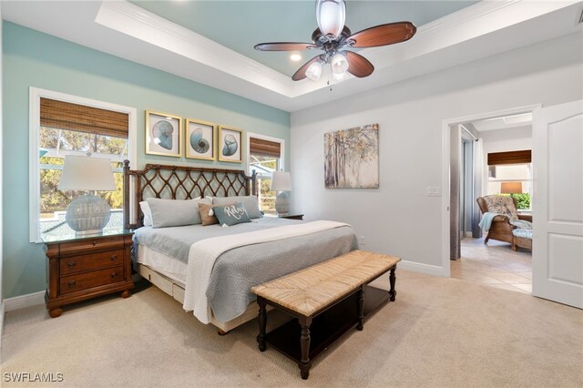 bedroom featuring light colored carpet, multiple windows, and ceiling fan