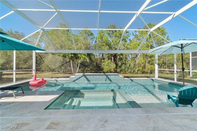 view of swimming pool with glass enclosure, an in ground hot tub, and a patio