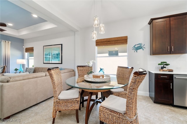 tiled dining area featuring crown molding