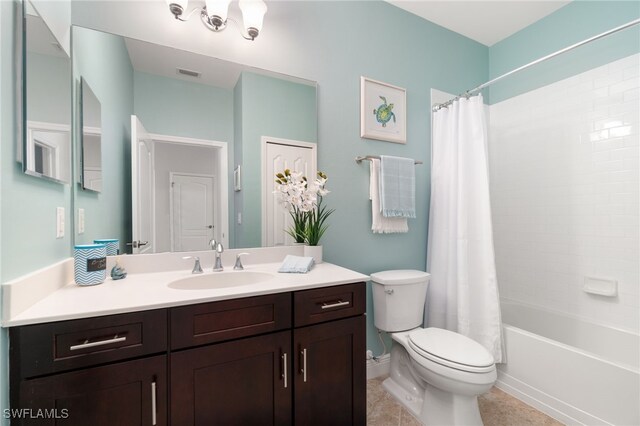 full bathroom featuring tile patterned flooring, shower / bath combination with curtain, vanity, and toilet