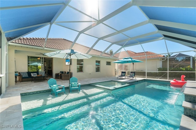 view of swimming pool with glass enclosure, an outdoor hangout area, ceiling fan, an in ground hot tub, and a patio area