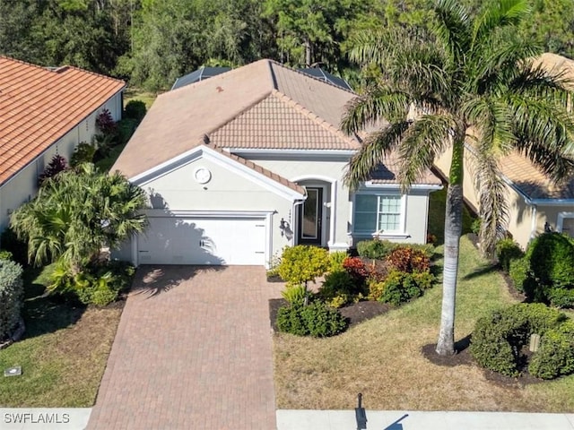 view of front of property with a front yard and a garage