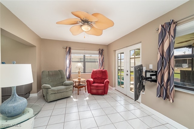 living area with ceiling fan, light tile patterned flooring, and french doors