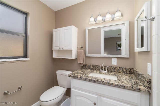 bathroom with vanity and toilet