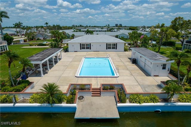 rear view of house with a patio area and a water view