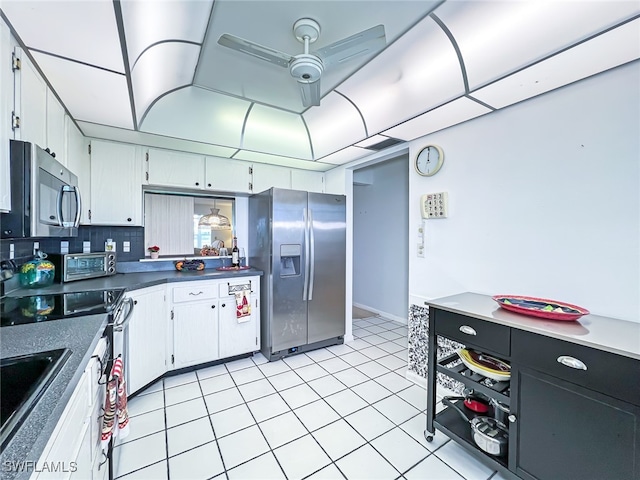 kitchen with ceiling fan, stainless steel appliances, light tile patterned floors, backsplash, and white cabinets