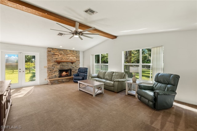 living room with vaulted ceiling with beams, plenty of natural light, carpet floors, and a stone fireplace