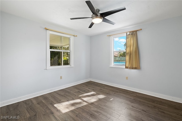 empty room featuring ceiling fan and dark wood-type flooring