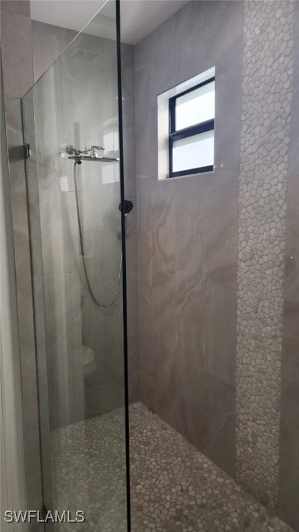 bathroom with a tile shower