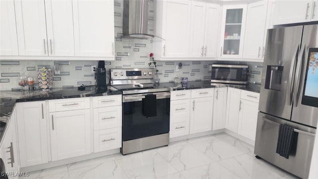 kitchen with stainless steel appliances, white cabinetry, tasteful backsplash, and wall chimney exhaust hood