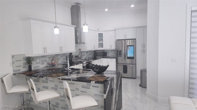 kitchen with kitchen peninsula, white cabinetry, pendant lighting, and stainless steel appliances