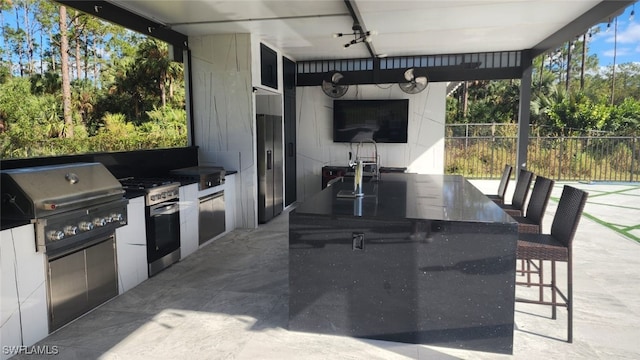 view of patio / terrace featuring area for grilling and exterior bar