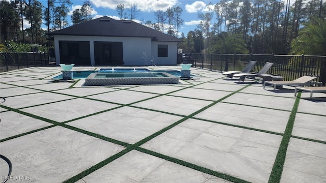 view of pool with a patio area and an in ground hot tub