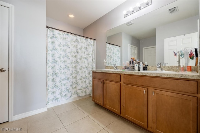 bathroom with tile patterned flooring and vanity