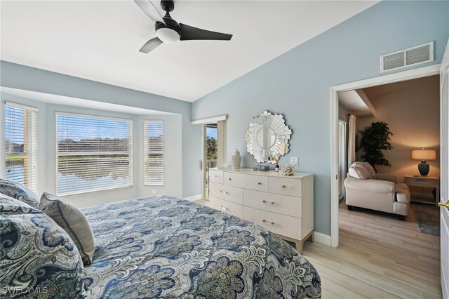 bedroom with vaulted ceiling, light hardwood / wood-style flooring, and ceiling fan