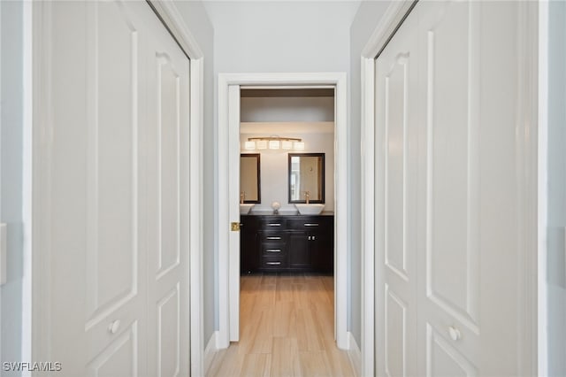 hall featuring light hardwood / wood-style flooring and sink