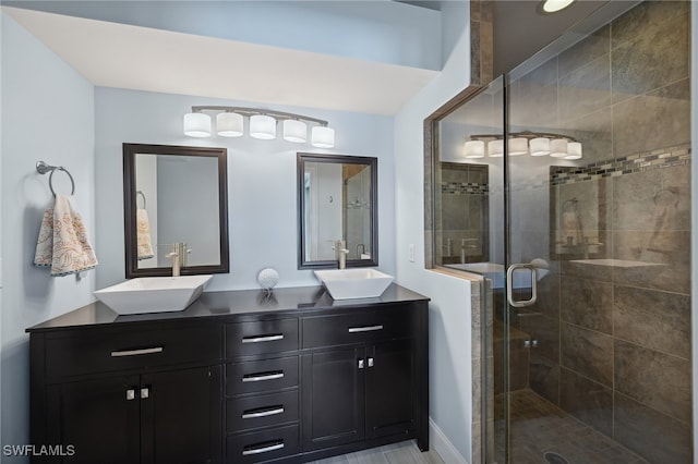 bathroom with vanity and a shower with shower door