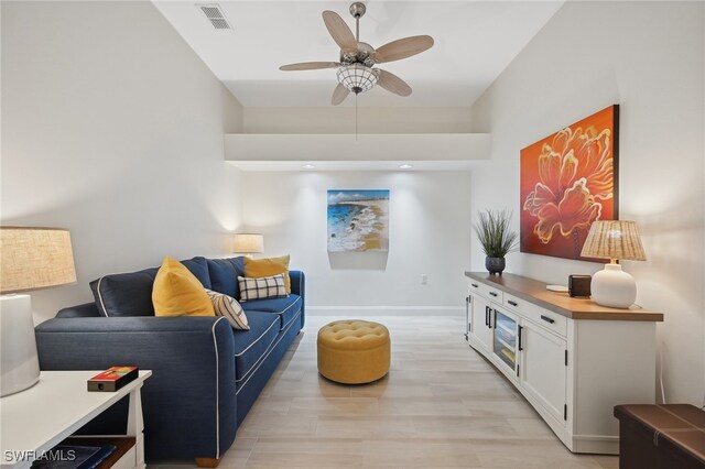 living room featuring ceiling fan and light hardwood / wood-style floors