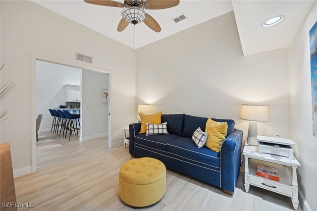 living room featuring ceiling fan and light wood-type flooring