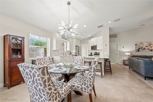 tiled dining room featuring sink and a chandelier