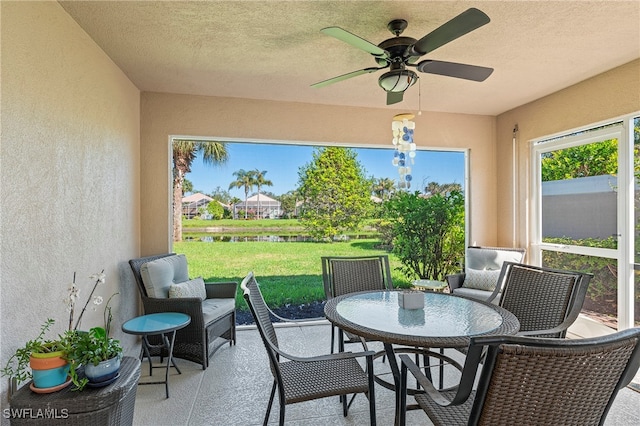 sunroom / solarium featuring ceiling fan