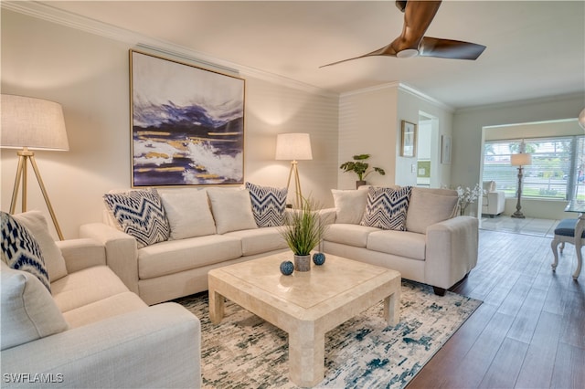 living room featuring hardwood / wood-style flooring, ceiling fan, and crown molding