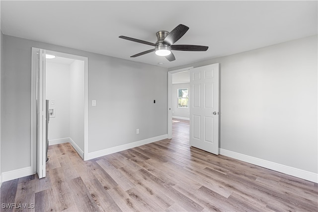 unfurnished room with ceiling fan and light wood-type flooring