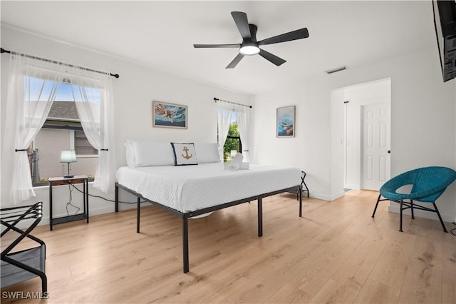 bedroom with light wood-type flooring and ceiling fan