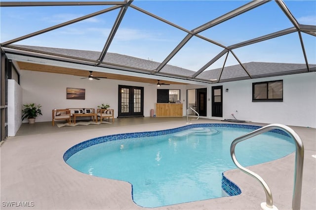 view of swimming pool with glass enclosure, a patio area, french doors, ceiling fan, and an outdoor hangout area