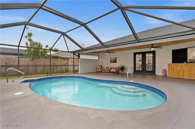 view of swimming pool featuring ceiling fan, a patio area, a lanai, and french doors