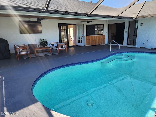 view of swimming pool with ceiling fan and area for grilling