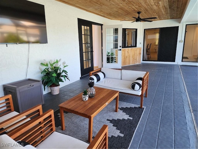 wooden terrace with an outdoor hangout area, french doors, and a ceiling fan