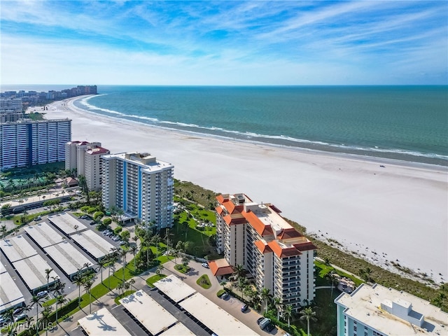 birds eye view of property featuring a water view and a beach view