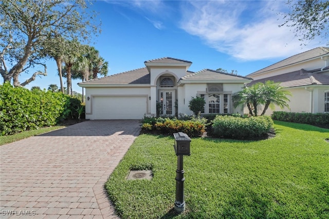 view of front of house featuring a front yard and a garage