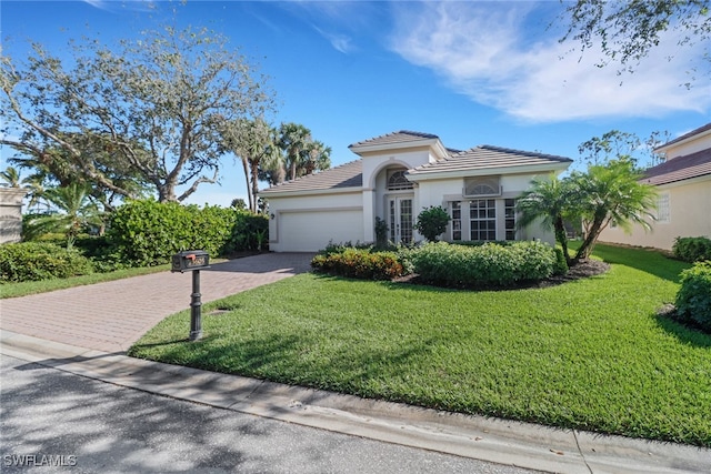 view of front of property featuring a garage and a front lawn