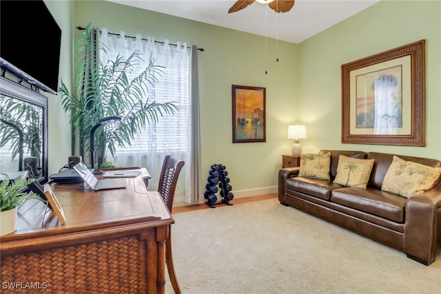 home office with ceiling fan and carpet