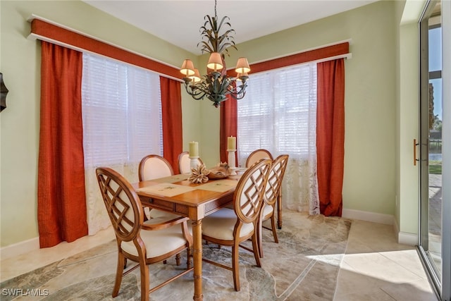 tiled dining room featuring a chandelier