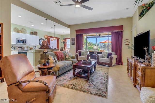 living room featuring ceiling fan with notable chandelier and light tile patterned floors