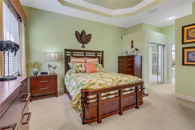 bedroom with connected bathroom, light carpet, and crown molding