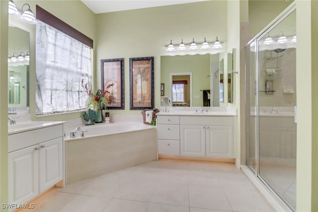 bathroom with tile patterned floors, vanity, and shower with separate bathtub