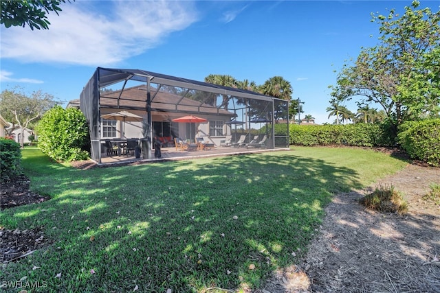 view of yard featuring glass enclosure and a patio