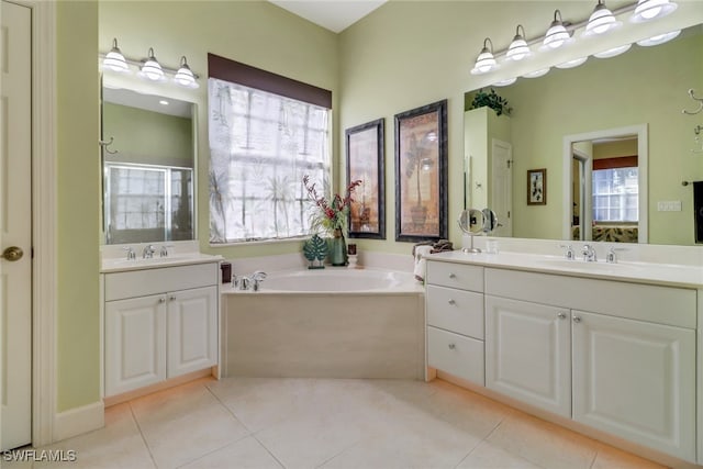 bathroom featuring tile patterned floors, a wealth of natural light, vanity, and separate shower and tub