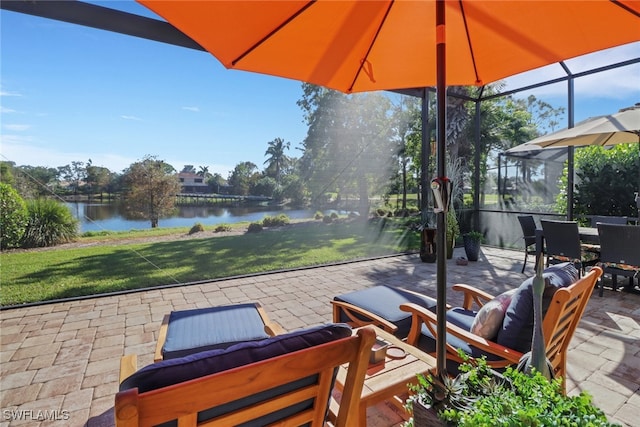 view of patio featuring a lanai, outdoor lounge area, and a water view