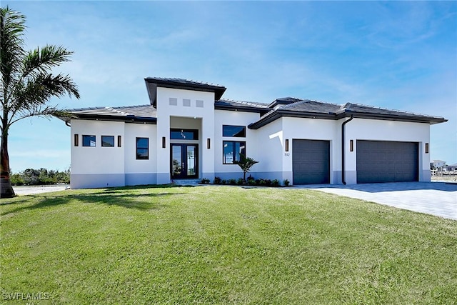 prairie-style home featuring a front lawn and a garage