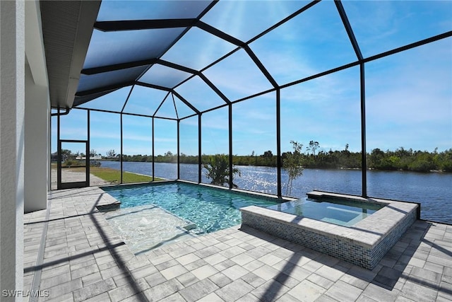 view of pool featuring glass enclosure, an in ground hot tub, a patio area, and a water view