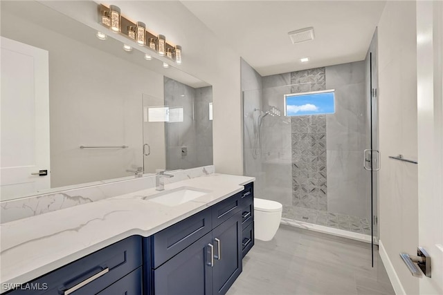 bathroom with vanity, toilet, and an enclosed shower