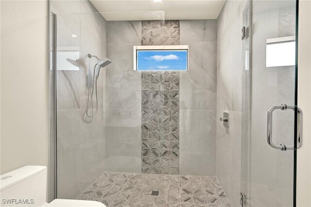 full bathroom with a shower stall and toilet